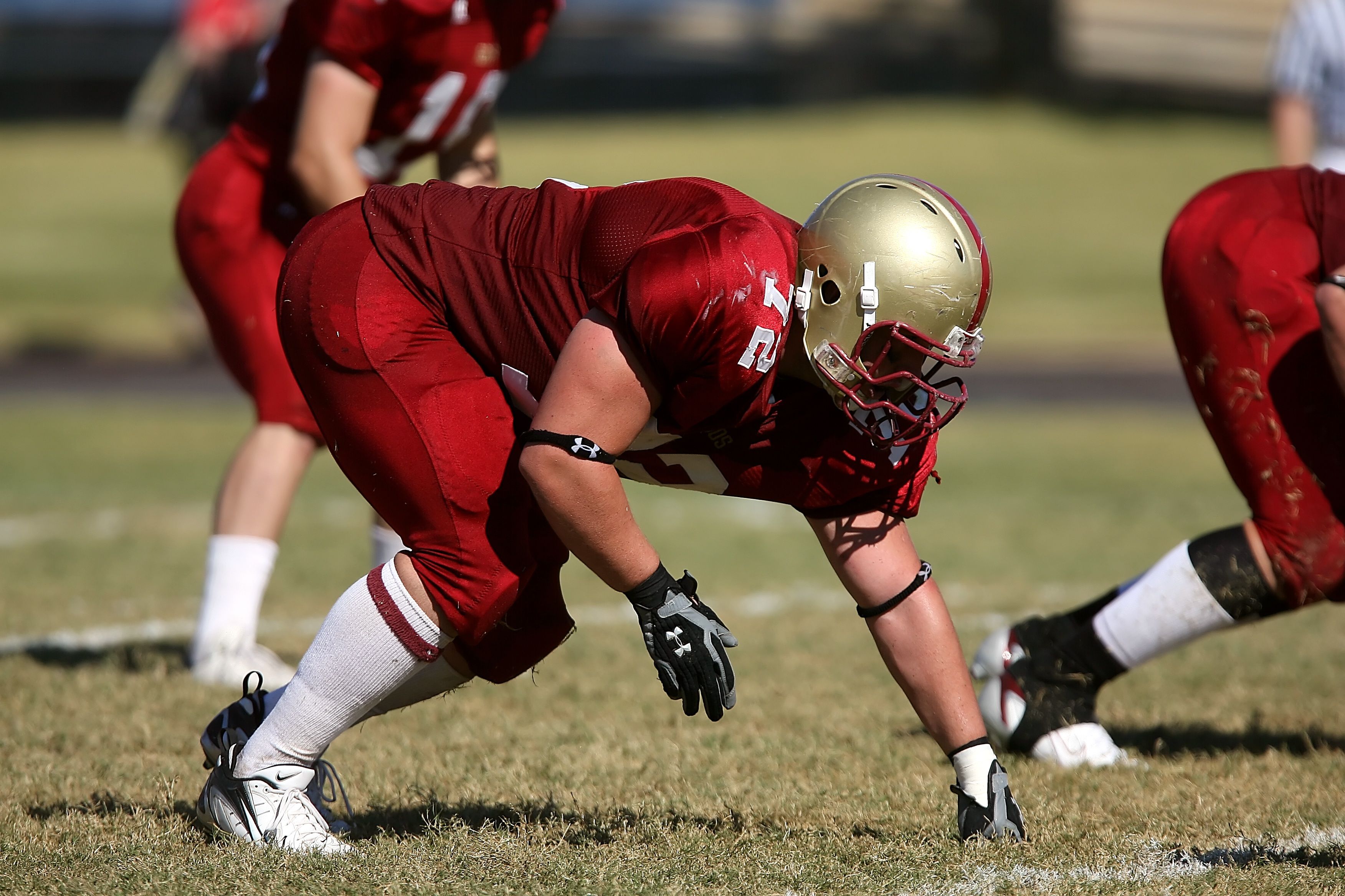 American football kicker in helmet on the field