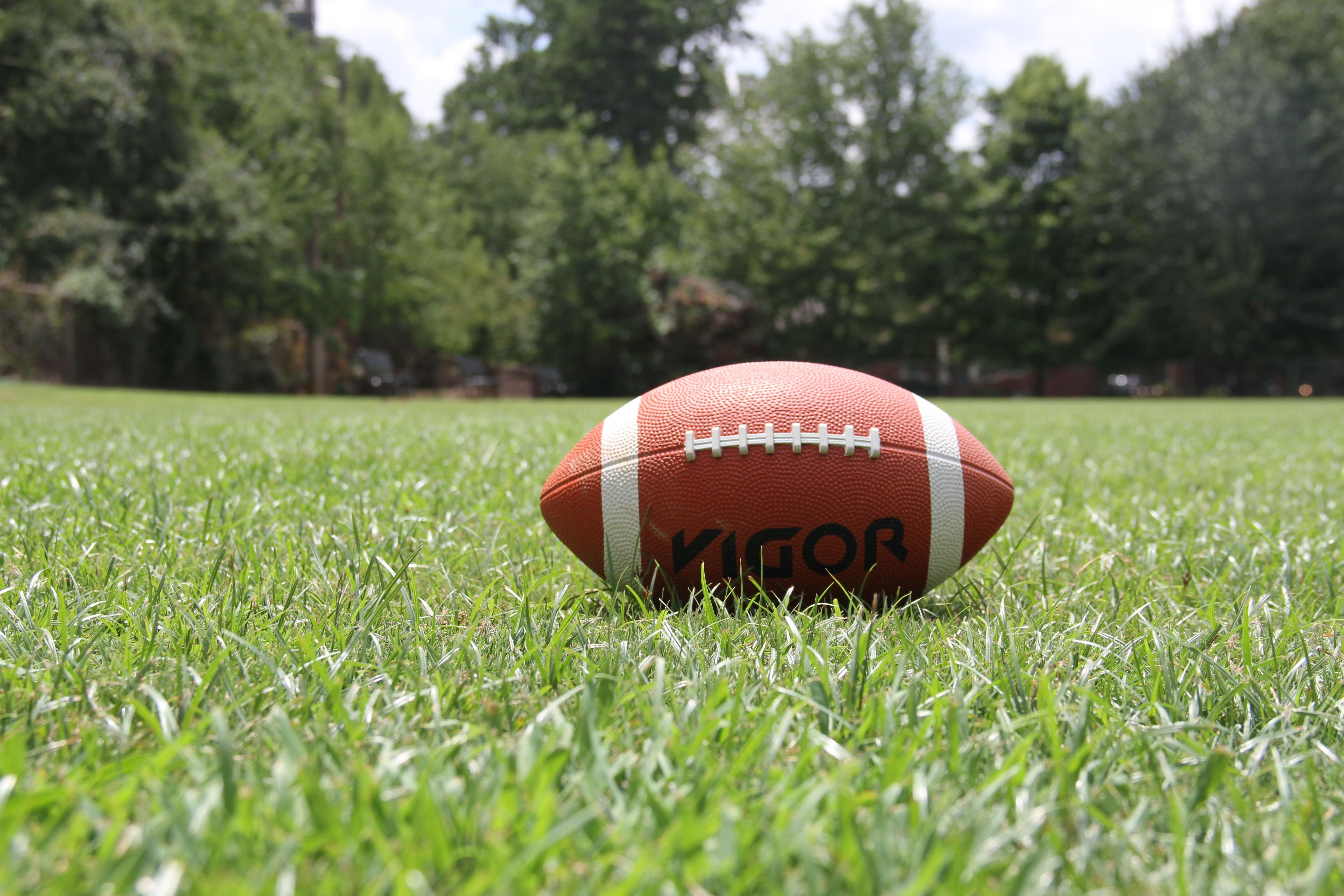 American football resting on the field