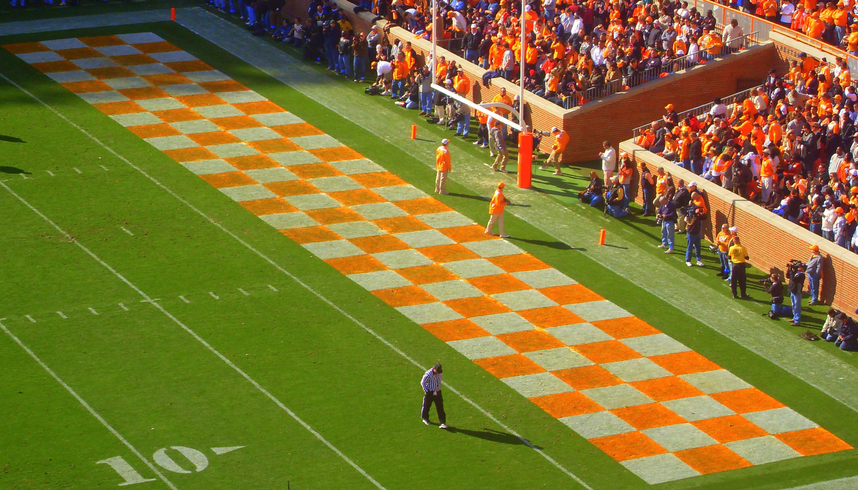 Football coaches reviewing an end-zone camera angle