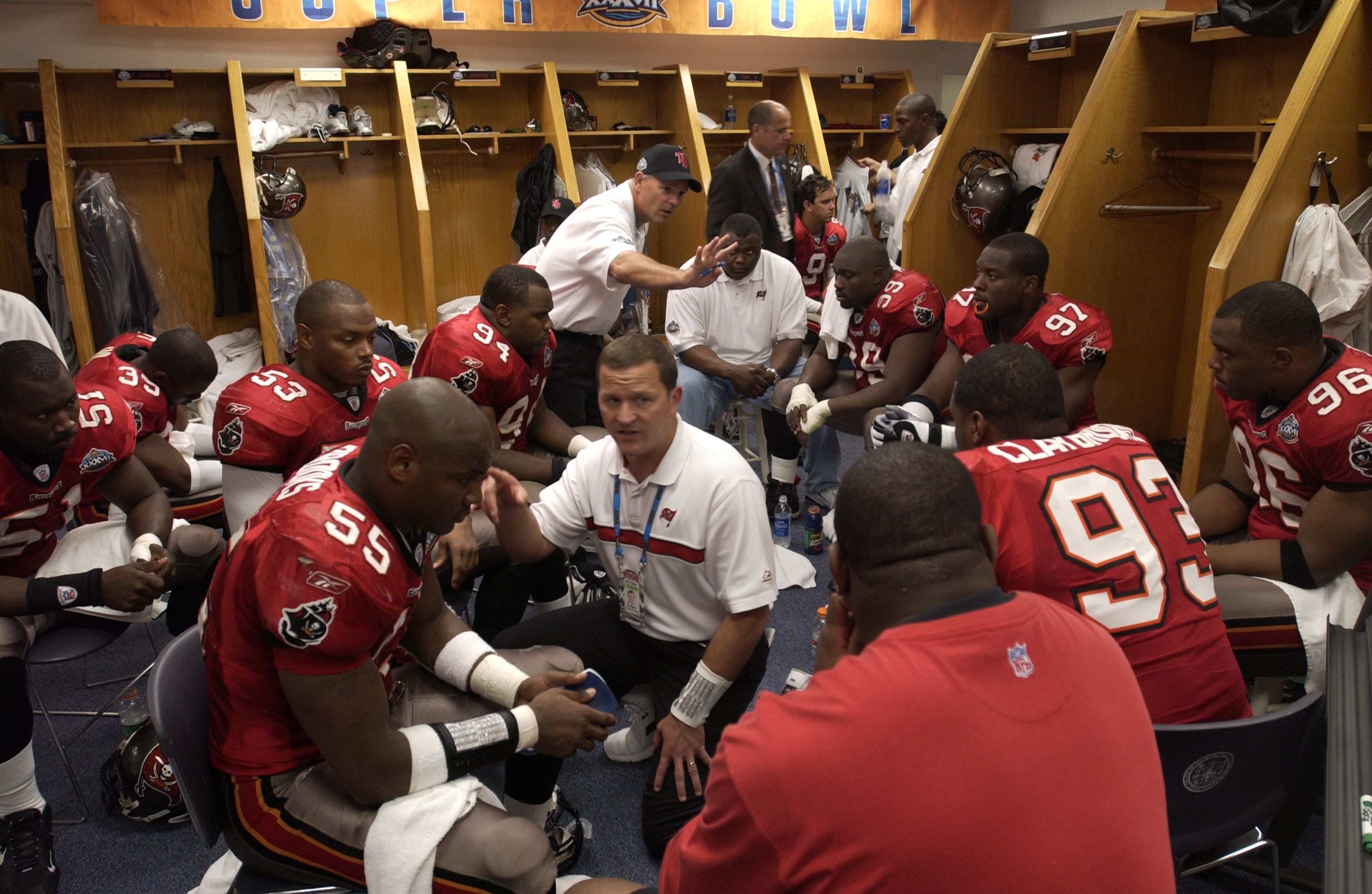 Football coaches using a tablet during halftime adjustments