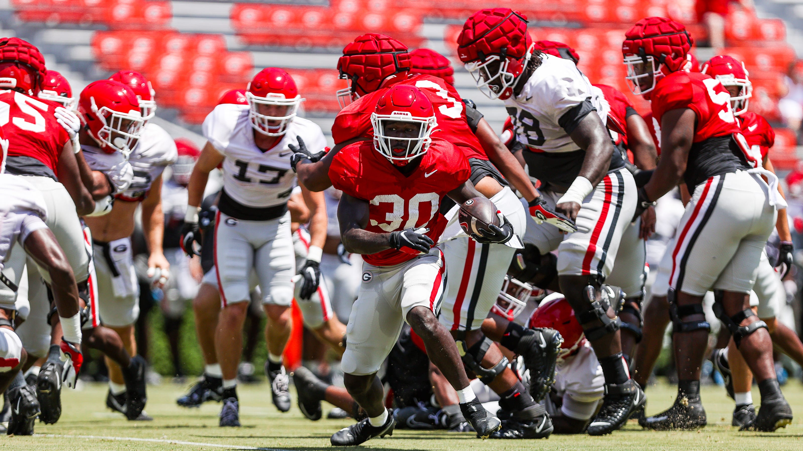 College football offensive linemen practicing together