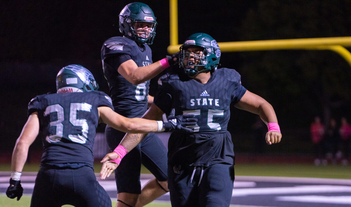 Defensive linemen executing a tackle-end pass-rush stunt