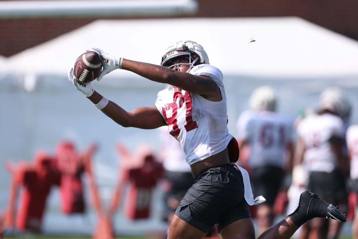 Tight end helping an offensive tackle with a chip block