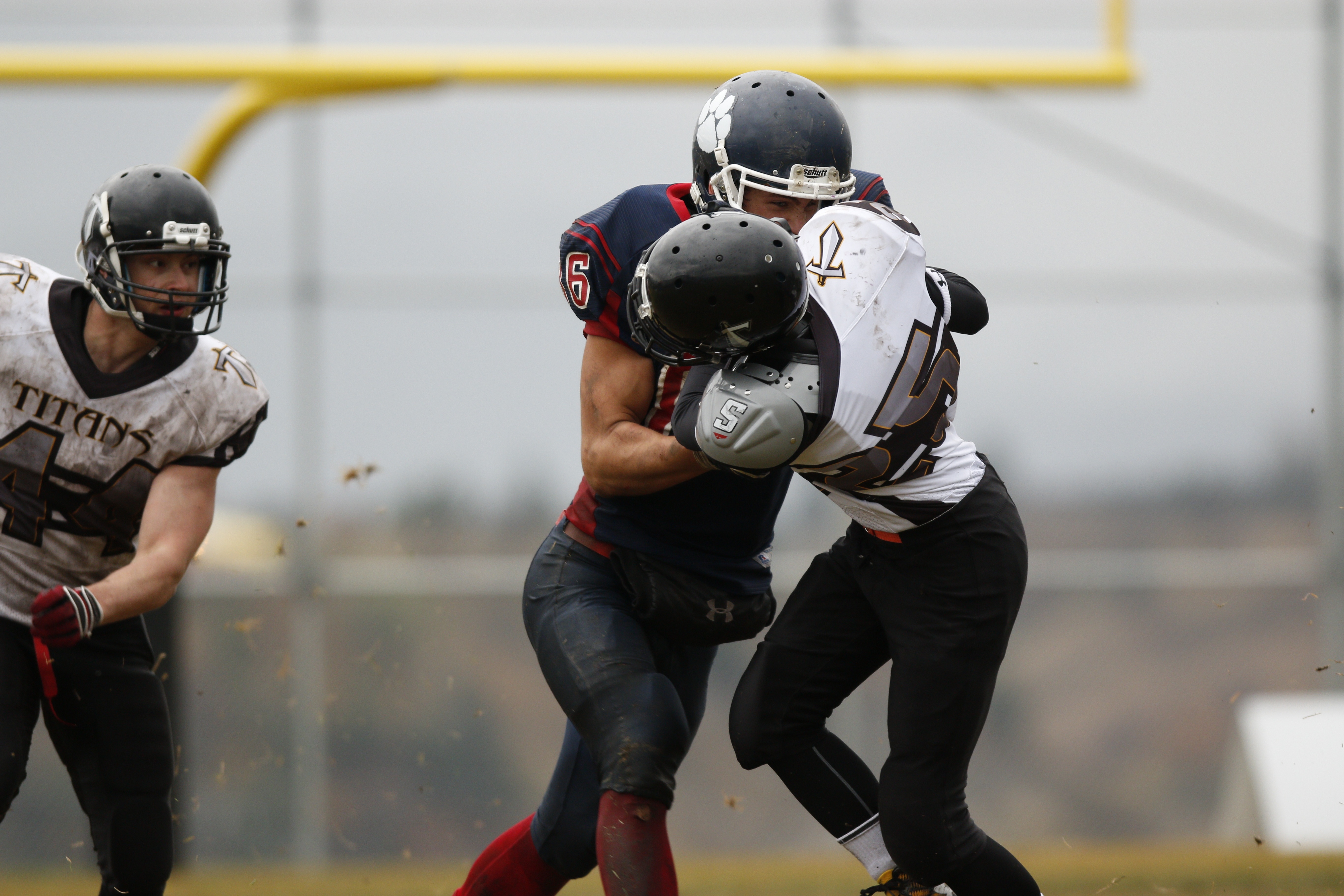 Football player practicing safer tackling technique with head up