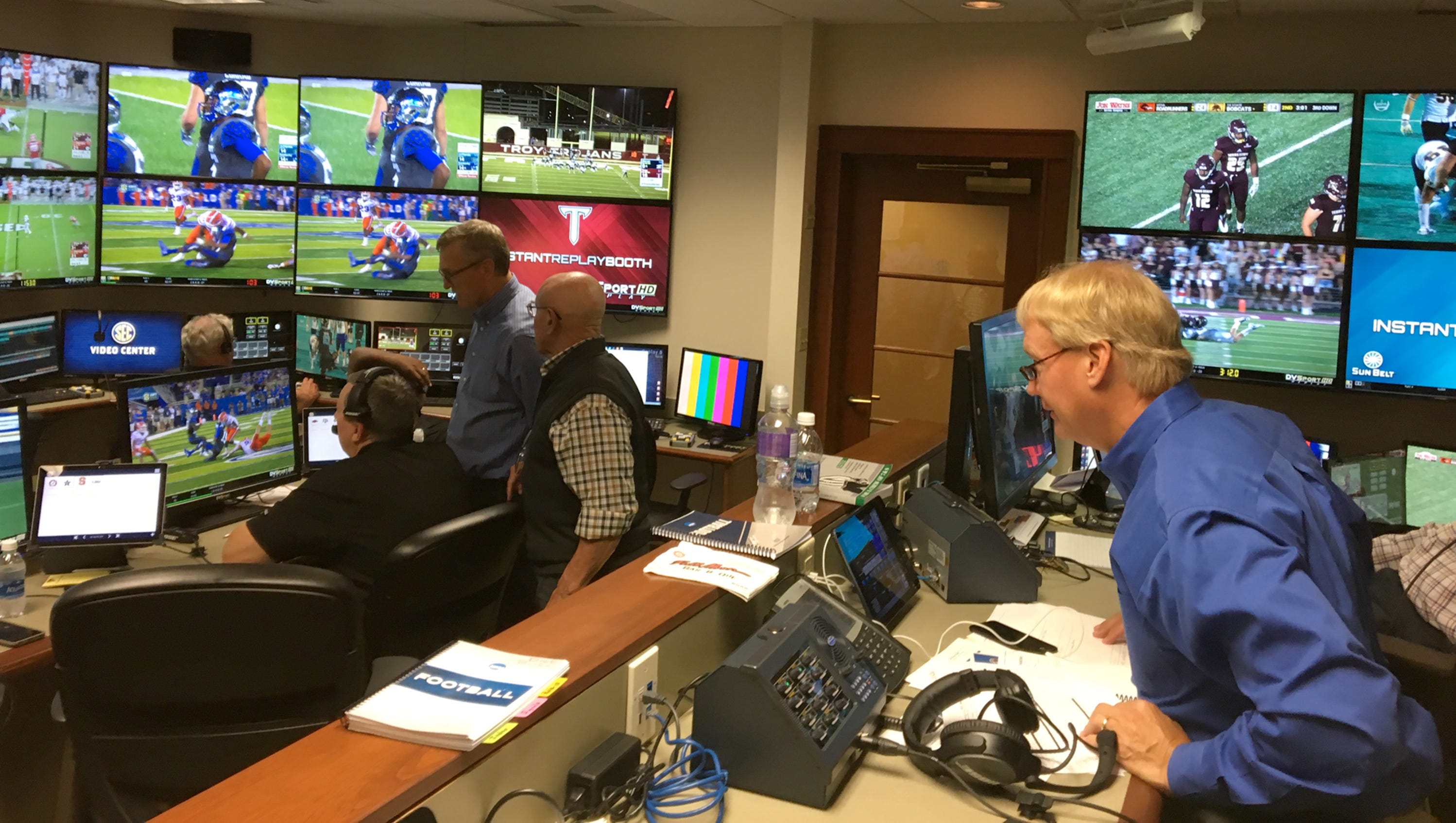 College football referee reviewing a targeting play on replay