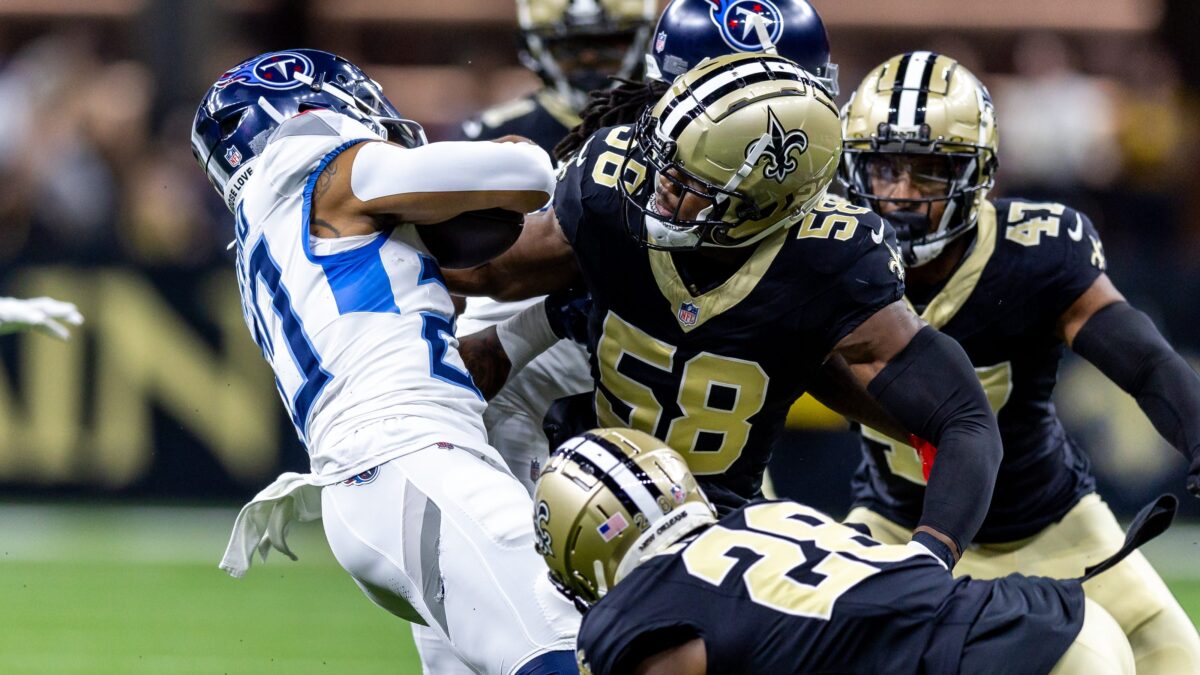 Special-teams coverage player making an open-field tackle
