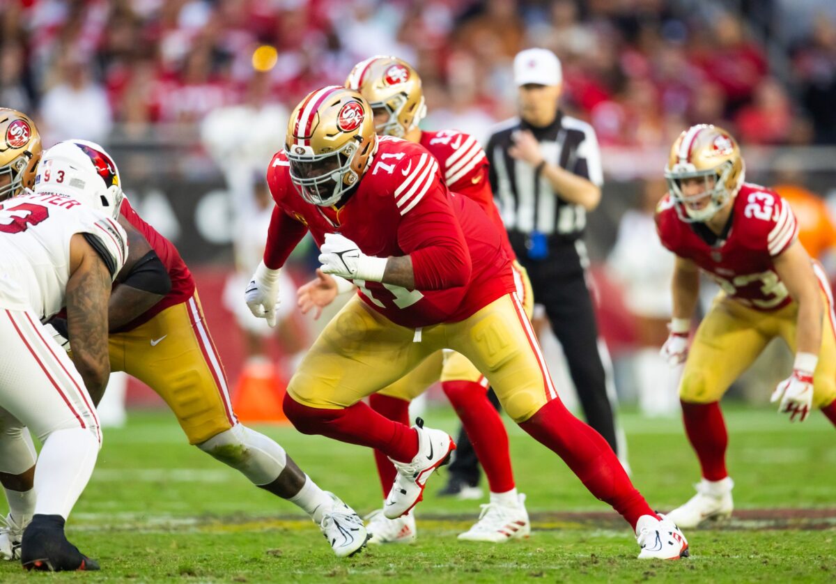 American football running play developing behind the offensive line