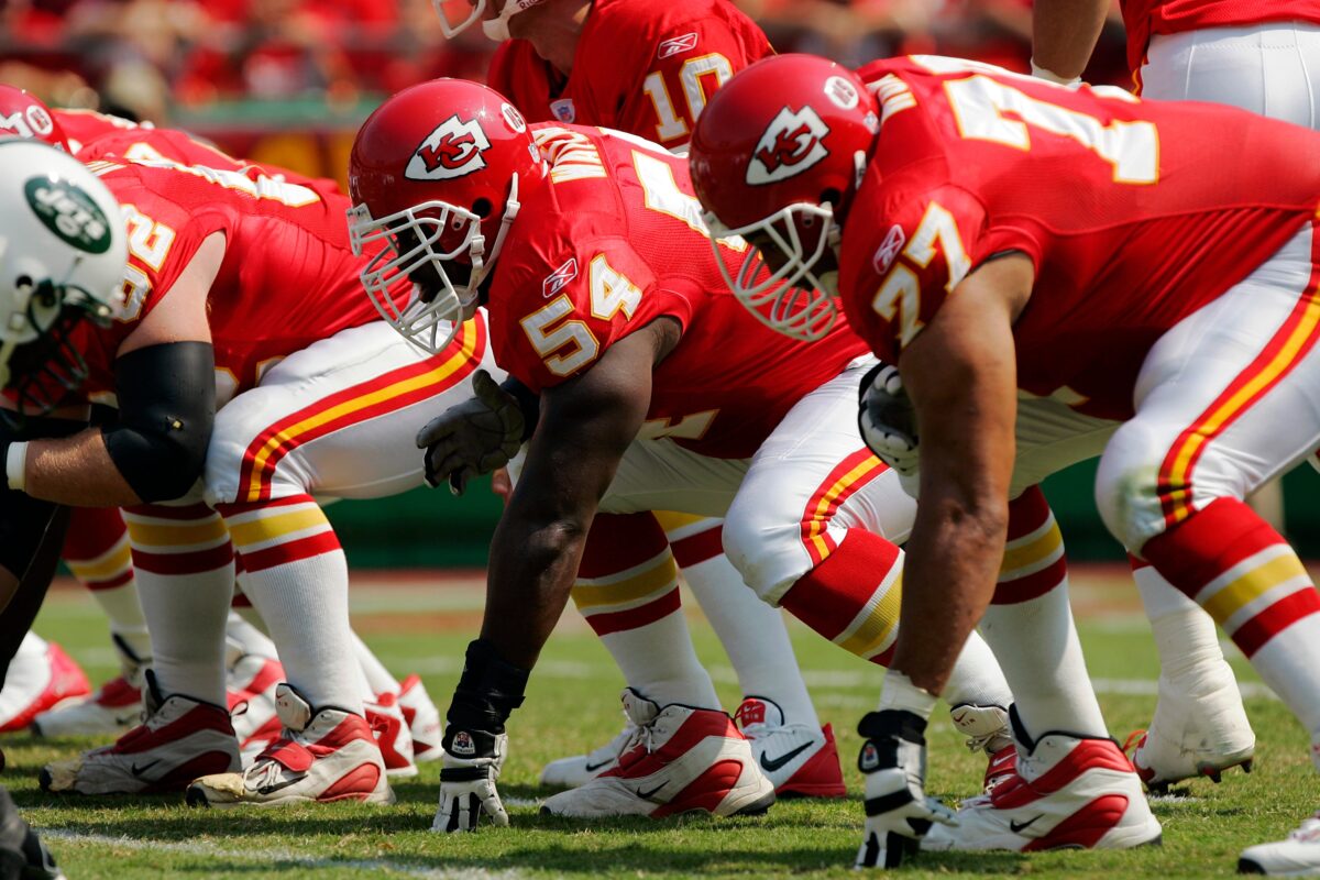 Offensive linemen creating a double team on a physical running play