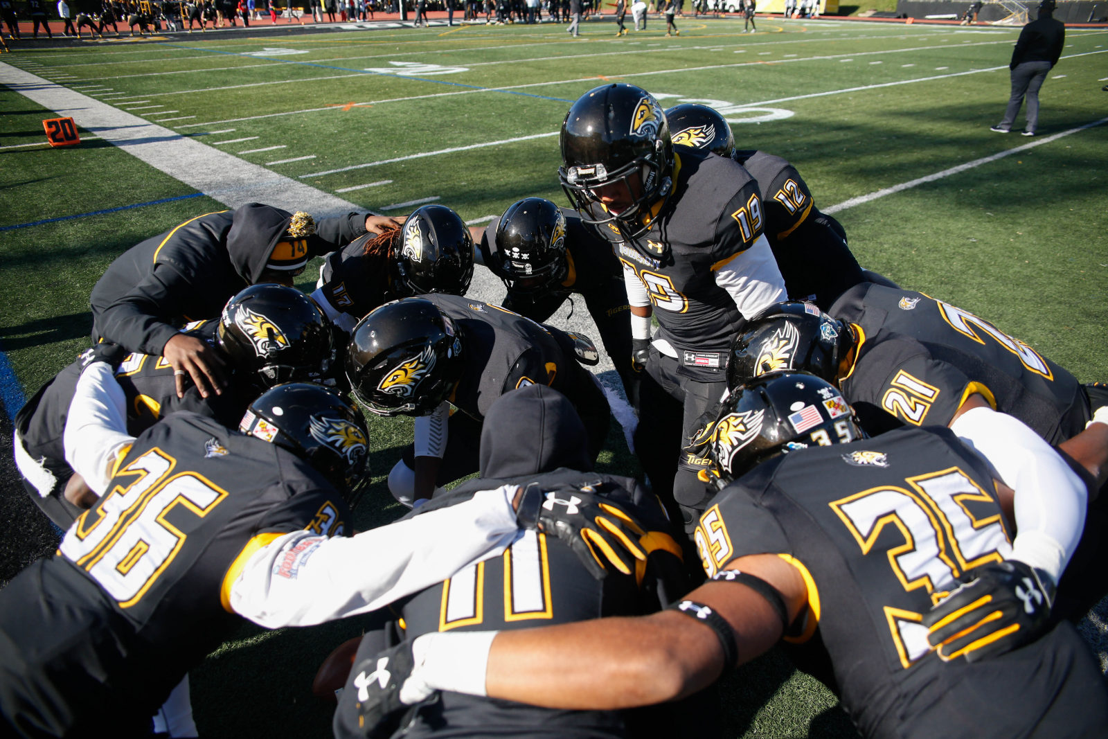 College football team huddling during practice