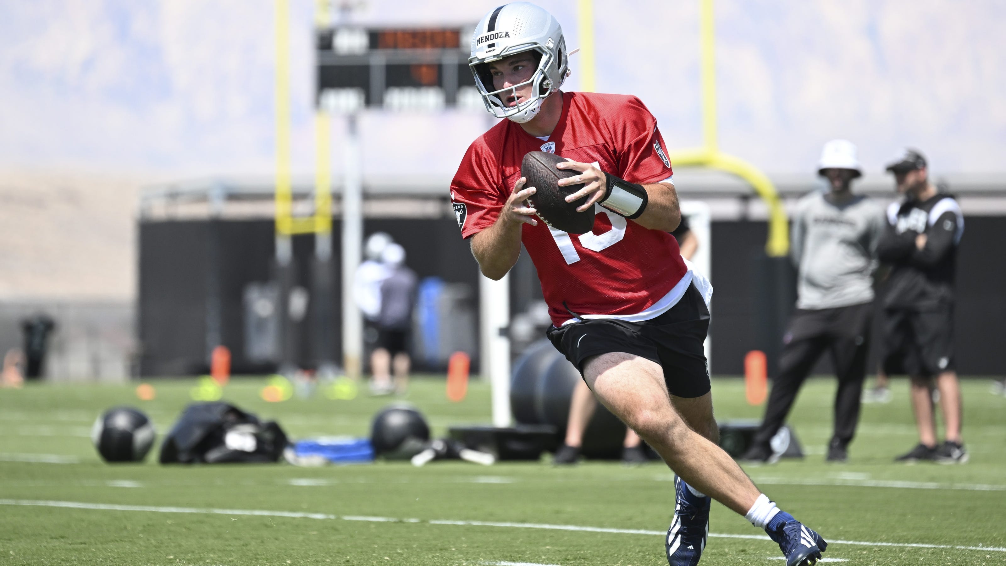 Quarterback practicing under-center footwork and drop mechanics